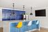 Indoor commuity area with bar and TV