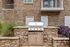 Chic outdoor grilling station set against a modern brick exterior, perfect for entertaining.
