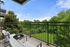 Charming balcony overlooking lush green landscape, perfect for relaxation and enjoying nature.