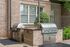 Chic outdoor grill station featuring stainless steel barbecues set against elegant brickwork, perfect for entertaining in style.
