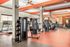 Modern fitness center featuring state-of-the-art exercise equipment, treadmills, and vibrant decor for an energizing workout experience.