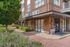 Inviting entrance to City Walk apartments with modern brick facade and landscaped pathway.