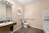 Elegant bathroom featuring a sleek design with a modern vanity, soothing wall art, and stylish lighting enhancing the tranquil ambiance.