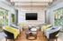 Chic contemporary lounge area featuring stylish armchairs, unique geometric decor, and modern lighting, perfect for relaxation and socializing.