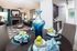 Luxurious open-plan living area with elegant dining setup, featuring vibrant decor, cozy fireplace, and sleek modern kitchen.