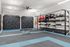 Modern fitness room featuring climbing walls and a well-equipped workout space with various exercise equipment.