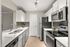 Modern kitchen with sleek stainless steel appliances, elegant white cabinetry, and chic tile backsplash, offering a stylish and functional culinary space.