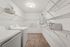 Spacious laundry room with modern washer, dryer, and ample shelving for organized storage.