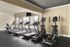 Modern fitness center with sleek treadmills and elliptical machines, featuring bright natural light for an invigorating workout experience.