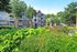 Charming apartment complex with brick facade and lush landscaped gardens in a serene neighborhood setting.