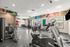 Modern fitness center featuring state-of-the-art exercise equipment, bright windows, and motivational wall art for an inspiring workout experience.