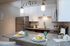 Modern kitchen with sleek granite countertops, stainless steel appliances, and stylish pendant lighting, perfect for entertaining.