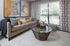 Chic living room with elegant sofa, vibrant cushions, and stylish decor, offering a cozy and inviting atmosphere.