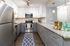 Modern kitchen with sleek stainless steel appliances, elegant granite countertops, and ample storage space in stylish cabinetry.