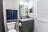 Chic bathroom with elegant granite countertop, modern fixtures, and plush navy towels, creating a serene oasis.