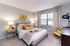 Chic and cozy bedroom with modern decor, plush bedding, and warm lighting, perfect for relaxation and comfort.