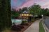 exterior pool and clubhouse two-story building at dusk