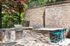 furnished grilling area with grills and seating on sunny day