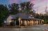 exterior one-story clubhouse with lighting at dusk