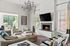 furnished clubroom with seating, fireplace and high ceilings
