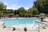 exterior pool with fountains and pavilion on sunny day