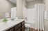 furnished bathroom with sink, toilet and bathtub in apartment home