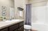 furnished bathroom with sink, toilet and bathtub in apartment home