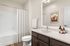 furnished bathroom with sink, toilet and bathtub in apartment home