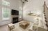 furnished living area with stairs and fireplace in townhome