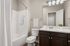 furnished bathroom with sink, toilet and bathtub in apartment home