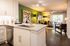 Bright and modern open-concept kitchen and living area with stylish decor and a view of a balcony.