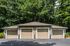 Charming garage space nestled in lush greenery, providing ample room and easy parking access.