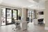 Bright home office with sleek desk, chairs, and large windows overlooking a serene courtyard.