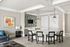 Bright and modern living area with stylish furniture, a sleek bar counter, and artistic decor.