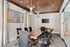 Chic conference room with wooden table, modern chairs, and stylish lighting fixtures.