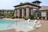 Chic apartment complex with a resort-style pool and comfortable lounging chairs.