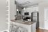 Modern kitchen with granite countertops, stainless steel appliances, and pendant lighting.