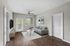 Stylish living room with a sleek gray sofa, wooden floor, and modern decor.