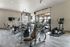 State-of-the-art gym with modern exercise equipment including treadmills and weight machines.