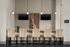 Chic resident lounge with a row of stylish chairs, dual mounted TVs, elegant pendant lighting, and modern decor.