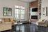 Inviting living room with elegant decor, featuring a plush sofa, stylish fireplace, and large sunlit windows.