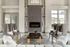 Sophisticated living room with fireplace, modern chairs, and a chic coffee table.