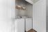 Compact laundry area with washer, dryer, and organized shelving for essentials.