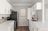 Modern kitchen with sleek white cabinetry, stainless steel appliances, and elegant countertops, perfect for culinary enthusiasts.