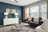 Bright and inviting living room featuring modern decor, a sleek black sofa, and elegant lighting against a rich accent wall.