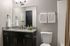 Elegant modern bathroom with sleek granite countertop, stylish fixtures, and soft lighting creating a serene atmosphere.