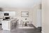 Modern apartment kitchen with sleek white cabinetry, granite countertops, and stylish open dining area with elegant decor.