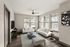 Bright and inviting modern living room featuring sleek white sofas, stylish glass coffee table, and large windows offering natural light.