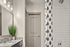 Stylish bathroom featuring a granite countertop, modern fixtures, and a chic shower curtain.