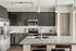 Sleek modern kitchen with dark cabinets, granite countertops, and stainless steel appliances.